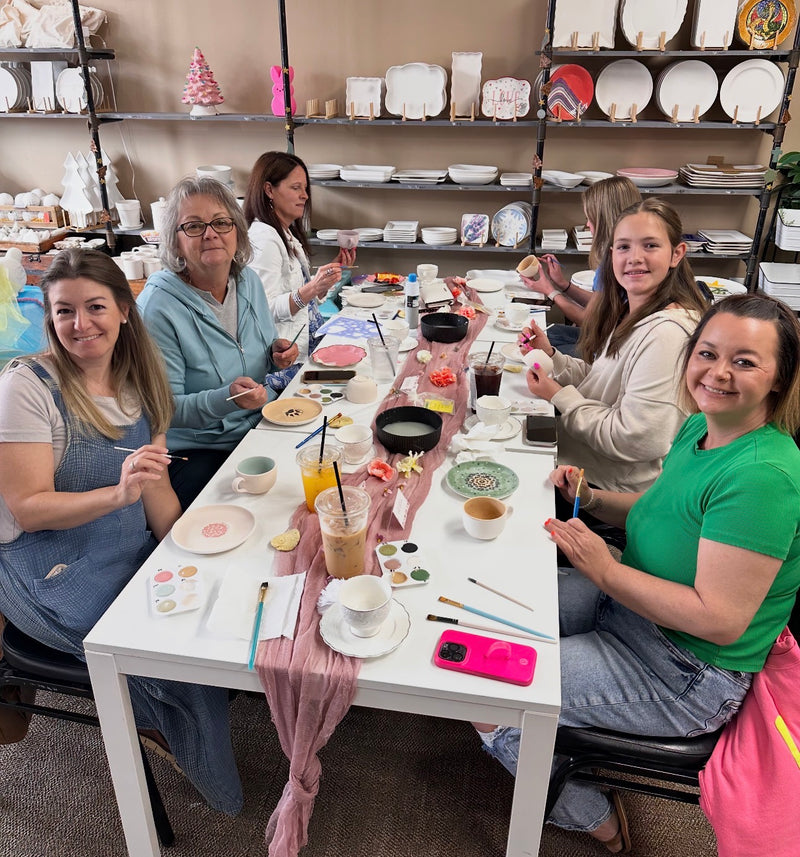 Group painting pottery together at a party at CREATIVE in Claremont, NC, near Hickory